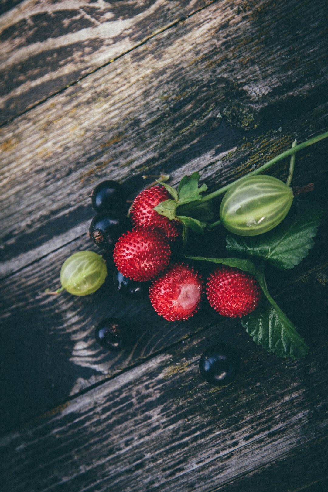 Fresh summer berries and vegetables on a garden table